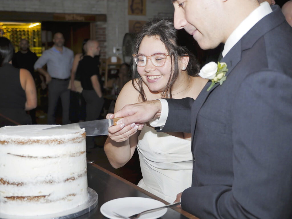 Newlyweds cutting their wedding cake together