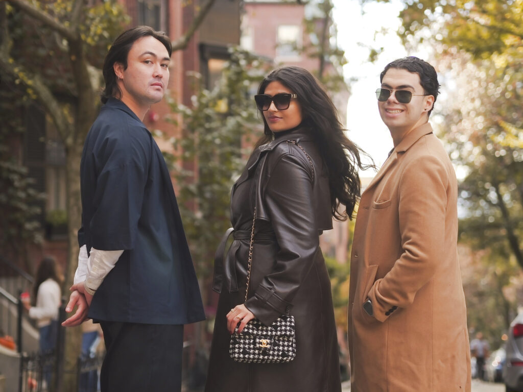 Three creatives walking a Boston street in autumn coats